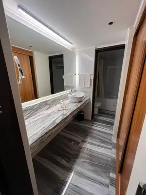 a bathroom with a sink and a large marble counter at Bayview Park Hotel Manila in Manila