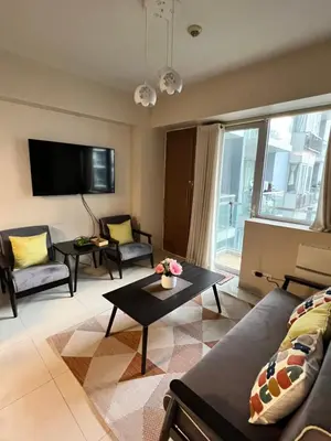 a living room with a couch and a table at Resorts World Condo in Manila