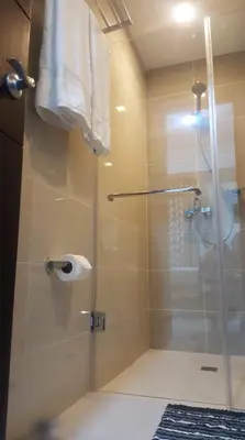 a shower with a glass door in a bathroom at 101 Newport Boulevard C1 in Manila