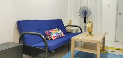a living room with a blue couch and a table at Julzhome PH Properties by Juliet AfricaPervaze in Santa Rosa
