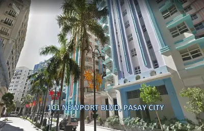 a rendering of a building in a city with palm trees at 101 Newport Blvd Condotel in Manila
