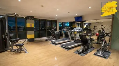 a gym with several treadmills and elliptical machines at KL Tower Makati Apartments by PH Staycation in Manila