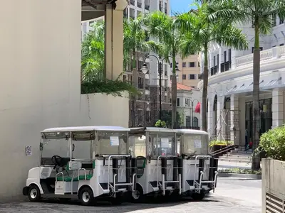 a golf cart parked in front of a building at Chillax Studio 101 Newport Boulevard in Manila