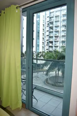 a sliding glass door with a view of a building at Palm Tree 2 Villas-Cluster 2 Unit 3N in Manila
