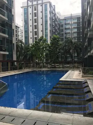 a swimming pool in a city with tall buildings at Palm Tree 2 Villas-Cluster 2 Unit 3N in Manila