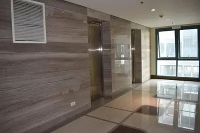 a lobby with a wooden wall with a elevator at Palm Tree 2 Villas-Cluster 2 Unit 3N in Manila