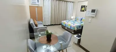 a small room with a dining table and a bedroom at Two Palm Tree Villas close to Manila Airport - Terminal 3 in Manila