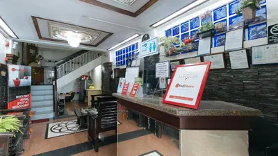 a restaurant with a counter with signs on the wall at L Mansion 2 Palanan Makati City in Manila