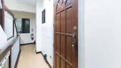 a hallway with a wooden door in a hospital at L Mansion 2 Palanan Makati City in Manila