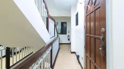 a hallway in a school with a door and stairs at L Mansion 2 Palanan Makati City in Manila