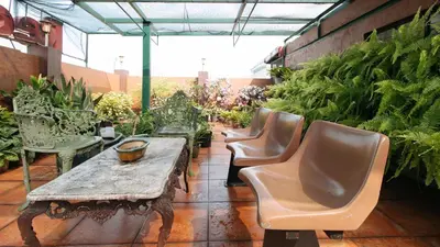 a group of chairs and a table in a garden at L Mansion 2 Palanan Makati City in Manila