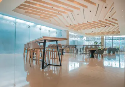 a room with chairs and a table and a table and chairs at Holiday Inn Express Manila Newport City by IHG in Manila