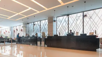 a lobby of an airport with people sitting at computers at Holiday Inn Express Manila Newport City by IHG in Manila
