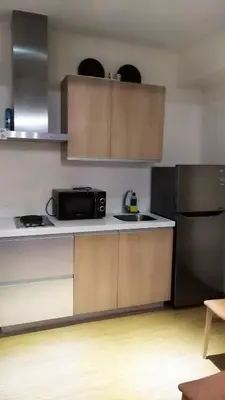 a kitchen with a microwave and a refrigerator at Azure C6 Balcony Wifi near Mall Airport MULTIPL UNITS in Manila