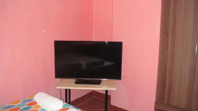 a flat screen tv sitting on a small table in a room at JCP Room Rentals in Manila