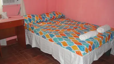 a bed with a colorful comforter in a room at JCP Room Rentals in Manila