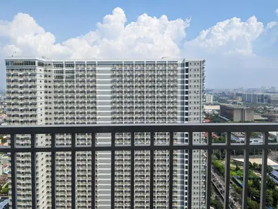a large white building in a city at Studio Condo Manila by the Bay Roxas Blvd near US Embassy in Manila