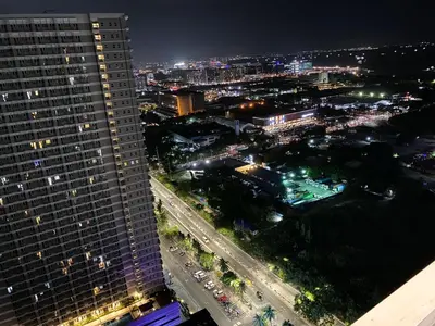 a view of a city at night with a tall building at Studio Condo Manila by the Bay Roxas Blvd near US Embassy in Manila