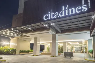 a dealership with a sign on the side of a building at Citadines Bay City Manila in Manila