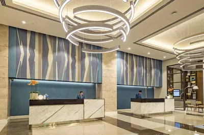 a rendering of a lobby with a large chandelier at Citadines Bay City Manila in Manila