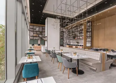 a rendering of a restaurant with tables and chairs at Citadines Bay City Manila in Manila