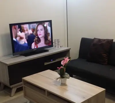 a living room with a flat screen tv and a coffee table at Makati Condo Edsa MRT Magallanes Station Chino Roces Ave cor EDSA IT Hub ONE Ayala Alphaland WiFi by 24K Residences in Manila