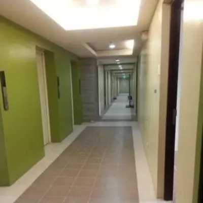 an empty hallway in a building with green walls at Makati Condo Edsa MRT Magallanes Station Chino Roces Ave cor EDSA IT Hub ONE Ayala Alphaland WiFi by 24K Residences in Manila