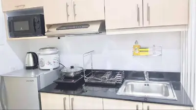 a small kitchen with a sink and a microwave at EV Place in Manila
