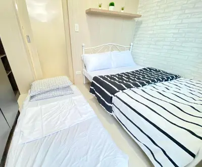 two beds in a room with two mattresses at Will’s Place at Jazz Makati in Manila