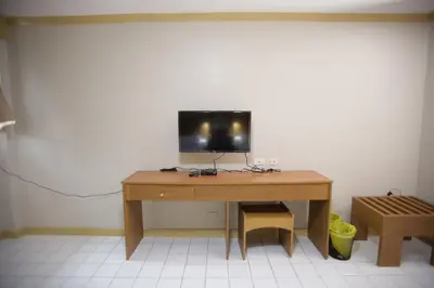 a wooden desk with a television on top of it at Hotel Soriente in Manila
