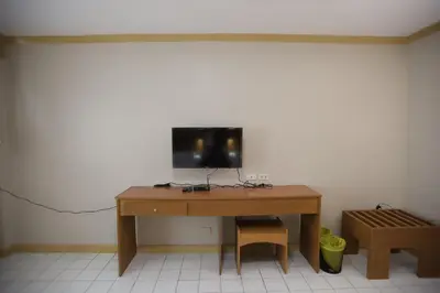 a wooden desk with a television on top of it at Hotel Soriente in Manila