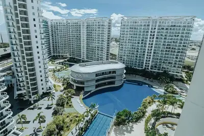 an aerial view of a large building with a pool at Azure Urban Resort Residences - The Paris Hilton Beach Club in Manila