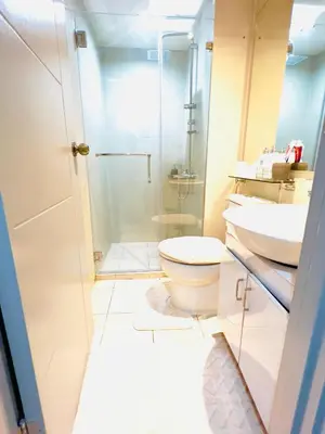 a bathroom with a toilet and a sink at Azure Urban Resort Residences - The Paris Hilton Beach Club in Manila