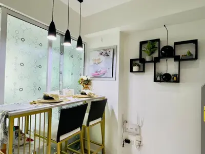 a dining room with a table and two chairs at Azure Urban Resort Residences - The Paris Hilton Beach Club in Manila