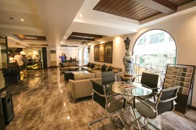 a lobby with a couch and a table and chairs at Royal Bellagio Hotel in Manila