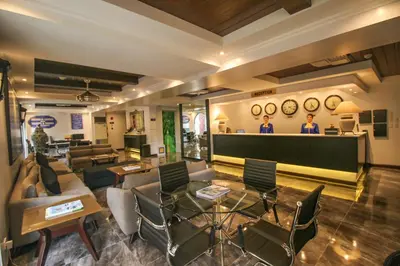 two men standing at the bar in a living room at Royal Bellagio Hotel in Manila