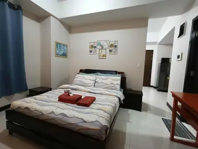 a bedroom with a bed with two towels on it at Condo Unit walking distance to Manila Airport (NAIA Terminal 3) in Manila