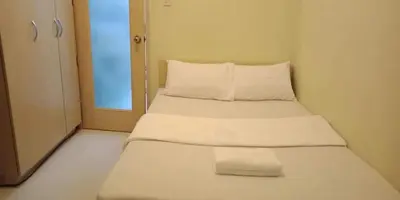 a pair of beds in a small room at CHATEAU ELYSEE a6 near AIRPORT Wifi Kitchen in Manila