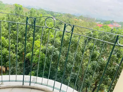 a balcony with a view of a forest at CHATEAU ELYSEE a6 near AIRPORT Wifi Kitchen in Manila