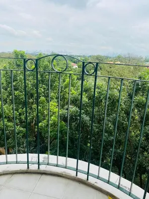 a iron fence with a view of a garden at CHATEAU ELYSEE a6 near AIRPORT Wifi Kitchen in Manila