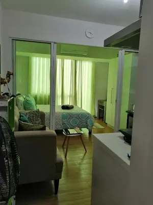 a living room with a bed and a couch at ACQUA Private Residences 1BR Condo in the heart of downtown Makati & Mandaluyong in Manila