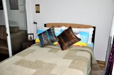 a bedroom with a bed with four pillows on it at ACQUA Private Residences 1BR Condo in the heart of downtown Makati & Mandaluyong in Manila