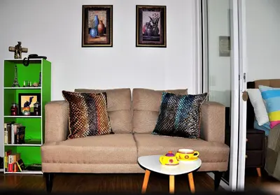 a living room with a couch and a table at ACQUA Private Residences 1BR Condo in the heart of downtown Makati & Mandaluyong in Manila