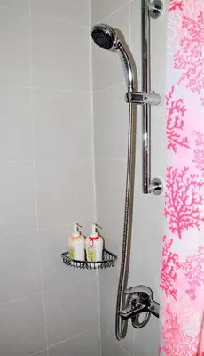 a shower with two candles on a shelf in a bathroom at ACQUA Private Residences 1BR Condo in the heart of downtown Makati & Mandaluyong in Manila