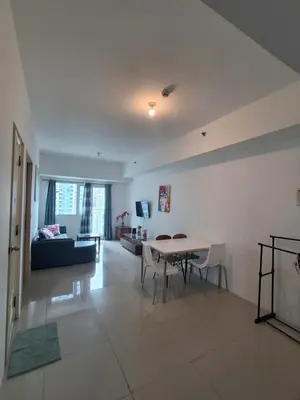 a living room with a table and a couch at Spacious 2BR in Jazz Residences Makati in Manila