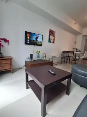 a living room with a coffee table and a couch at Spacious 2BR in Jazz Residences Makati in Manila