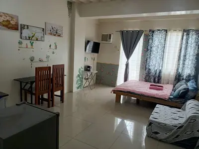a living room with a couch and a table at Mavs transient inn kassel residences in Manila