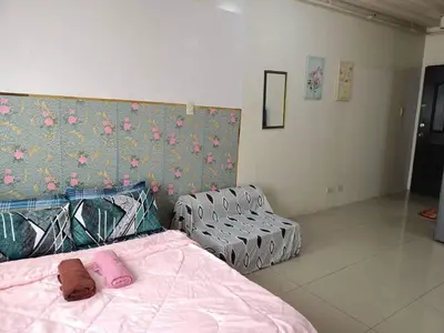 a bedroom with a bed with a pink blanket at Mavs transient inn kassel residences in Manila