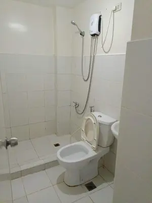 a bathroom with a toilet with the seat up at Mavs transient inn kassel residences in Manila