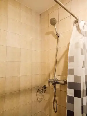 a shower in a bathroom with a shower curtain at Forbes Area BGC Taguig Manila in Manila
